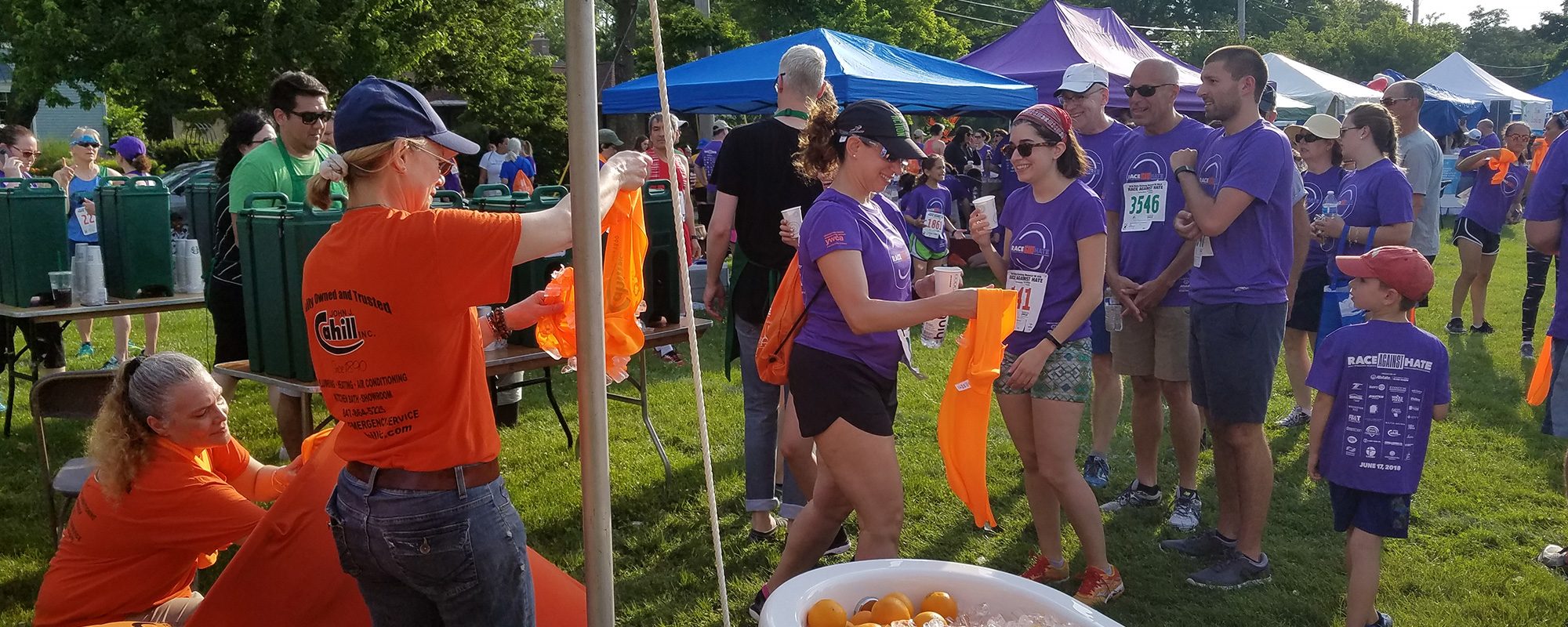 Several people wearing John J. Cahill Inc. shirts at a community event representing the company's community involvement in Evanston, IL