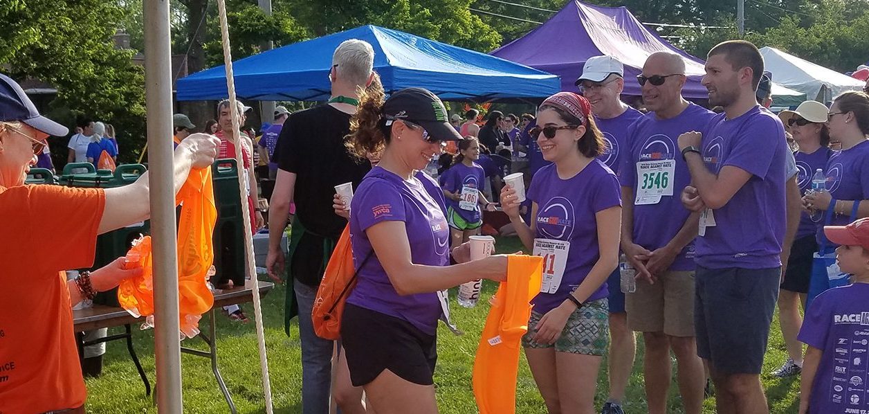 Several people wearing John J. Cahill Inc. shirts at a community event representing the company's community involvement in Evanston, IL